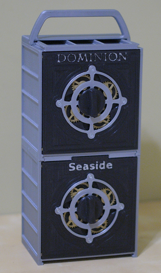 Storage boxes for the original Dominion card game and the Seaside expansion Black and silver storage boxes for Dominion and the Seaside expansion stacked with a handle on top