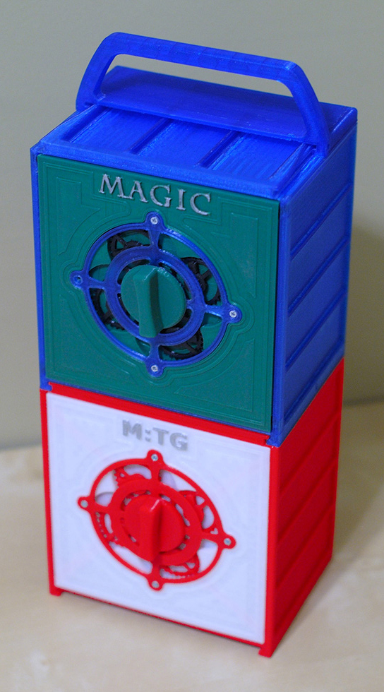 Storage boxes for Magic: The Gathering cards Two multicolored storage boxes for Magic: The Gathering decks, stacked with a handle on top