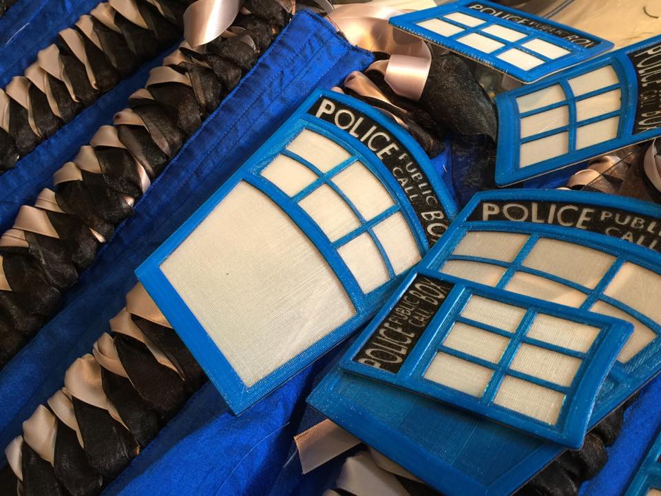TARDIS panels with materials for corsets. Image copyright: Nikki Cohen, MayFaire Moon stack of 3D printed TARDIS panels on top of corset fabric